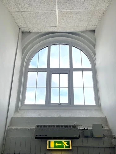 Arched window with several panels.